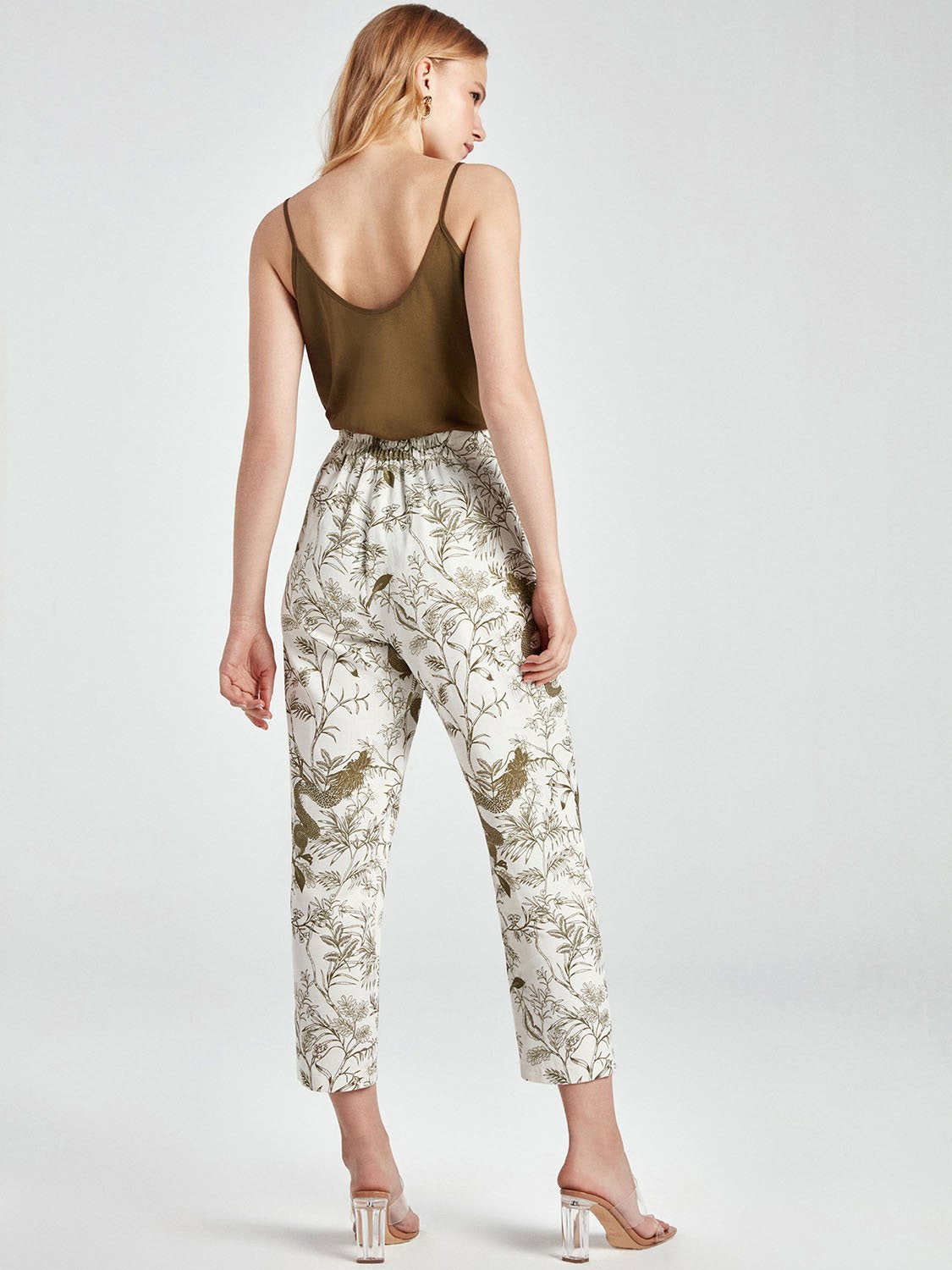 A pair of stylish printed ankle-length pants featuring side pockets and an elastic waistband, perfect for casual or dressy occasions.