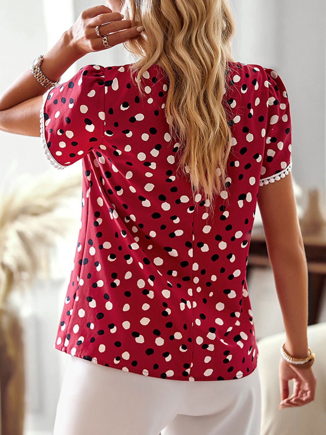 A stylish Printed Petal Sleeve Round Neck Blouse featuring a chic printed design, puff short sleeves, and a round neckline, perfect for casual wear.