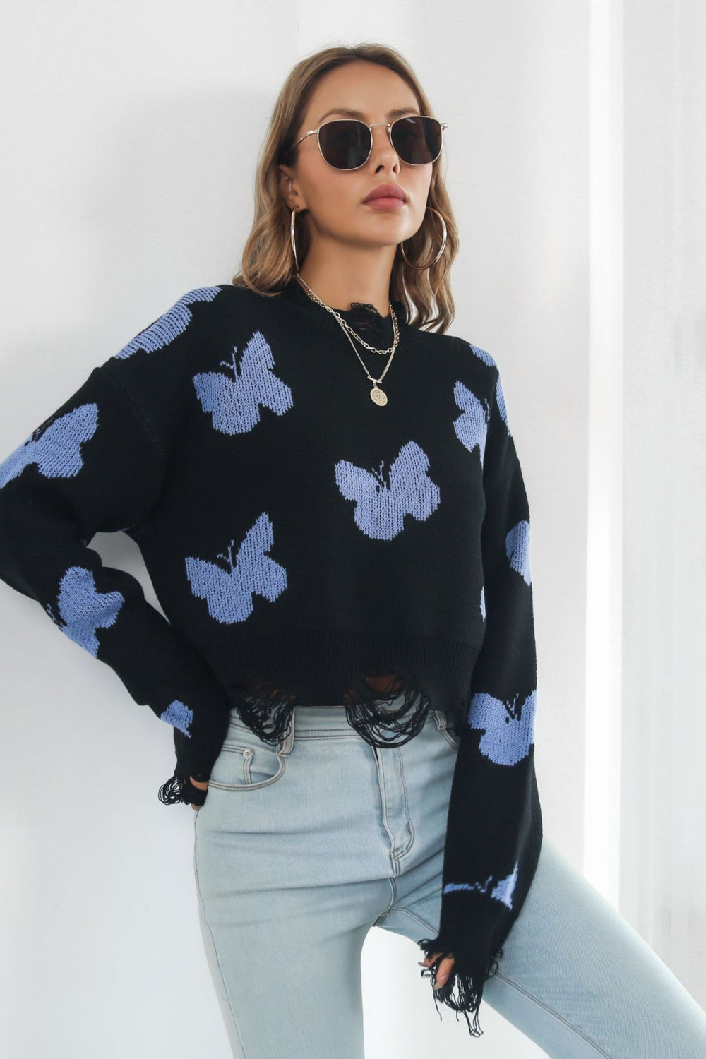 A stylish Printed Round Neck Ribbed Long Sleeve Sweater featuring a unique pattern, cropped length, and long sleeves, made from soft acrylic material.