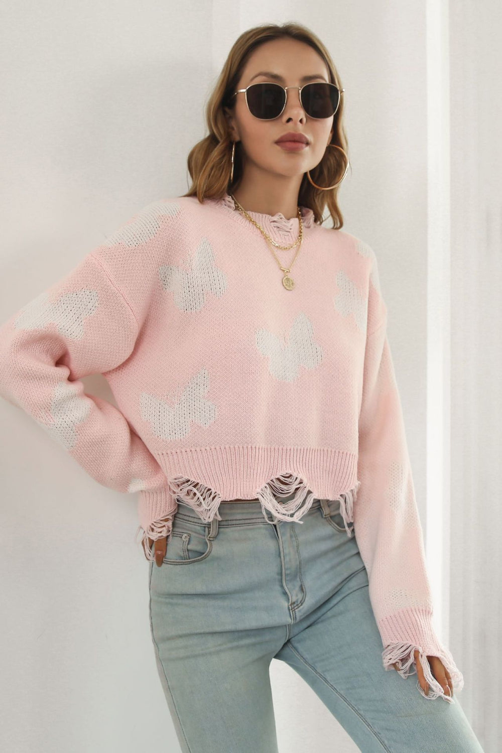 A stylish Printed Round Neck Ribbed Long Sleeve Sweater featuring a unique pattern, cropped length, and long sleeves, made from soft acrylic material.