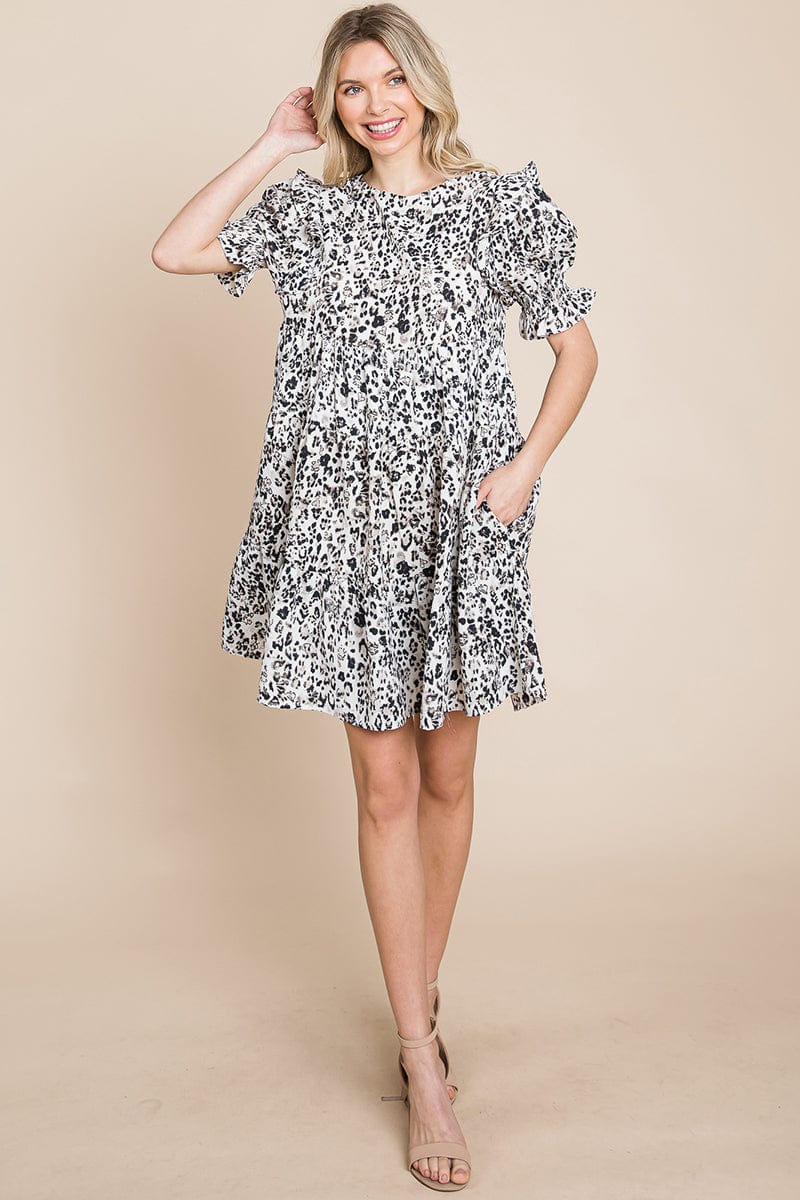 A stylish Printed Ruffle Short Sleeve Tiered Swing Dress featuring layered design, short puff sleeves, and vibrant abstract print with side pockets.