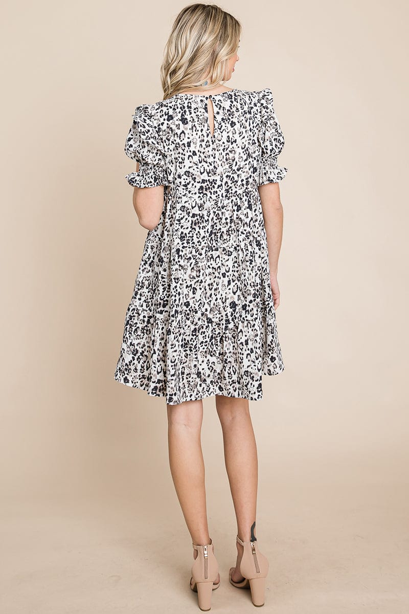 A stylish Printed Ruffle Short Sleeve Tiered Swing Dress featuring layered design, short puff sleeves, and vibrant abstract print with side pockets.