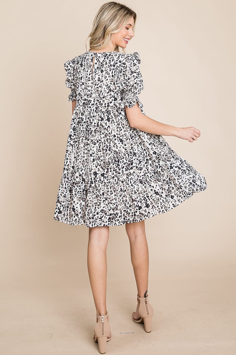 A stylish Printed Ruffle Short Sleeve Tiered Swing Dress featuring layered design, short puff sleeves, and vibrant abstract print with side pockets.