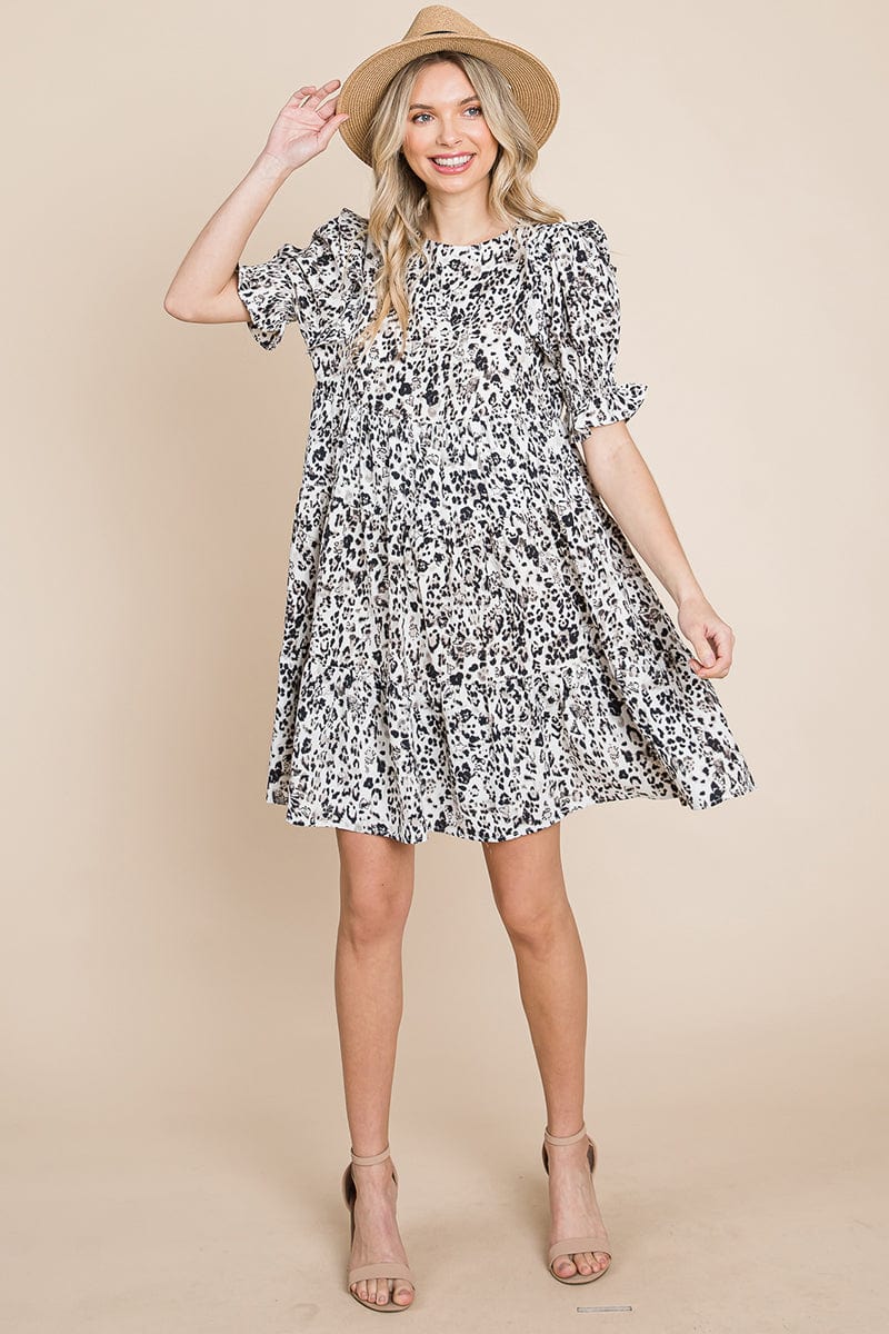 A stylish Printed Ruffle Short Sleeve Tiered Swing Dress featuring layered design, short puff sleeves, and vibrant abstract print with side pockets.