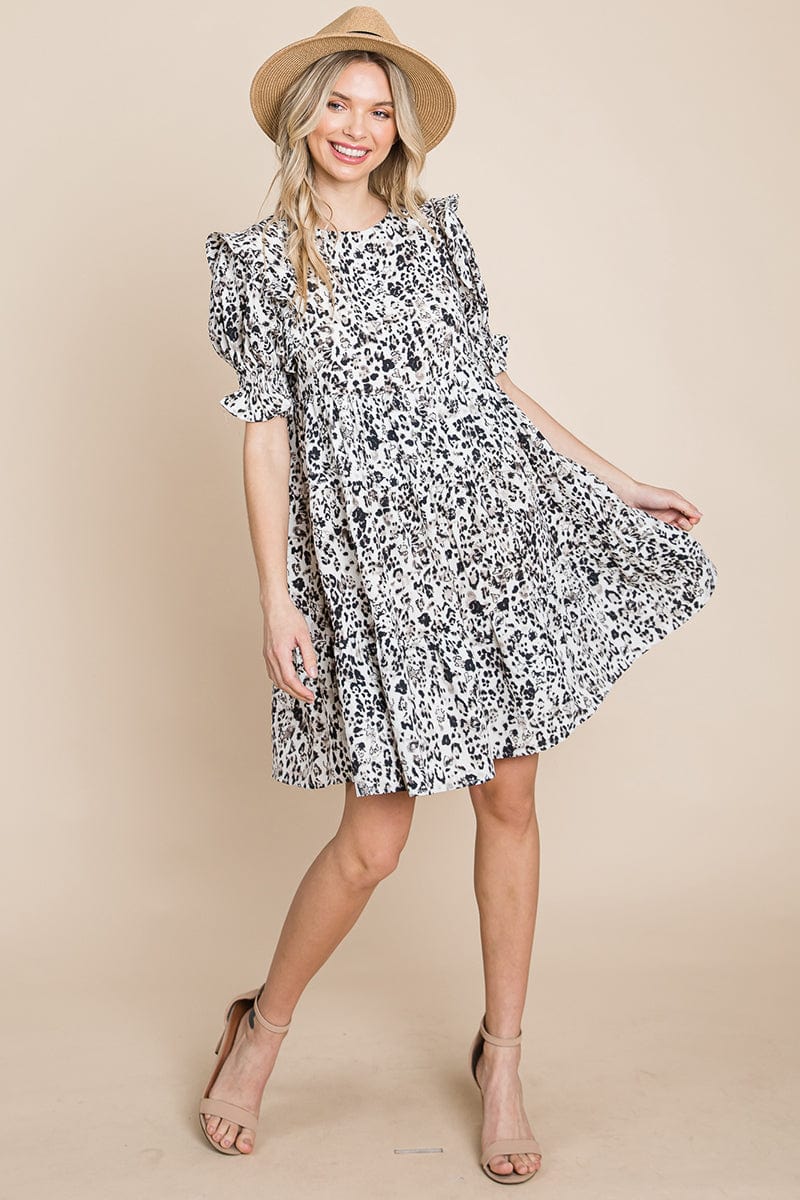 A stylish Printed Ruffle Short Sleeve Tiered Swing Dress featuring layered design, short puff sleeves, and vibrant abstract print with side pockets.