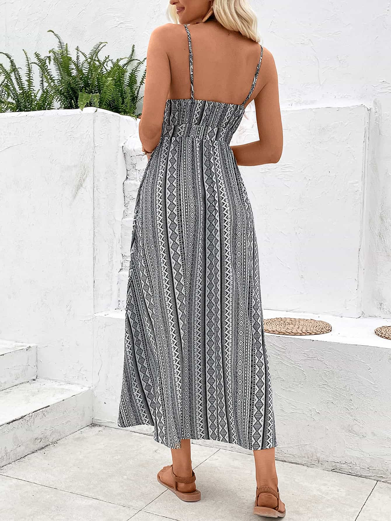 A stylish Printed Spaghetti Strap Slit Dress featuring a vibrant pattern, V-neckline, and a maxi length with a slit hem.