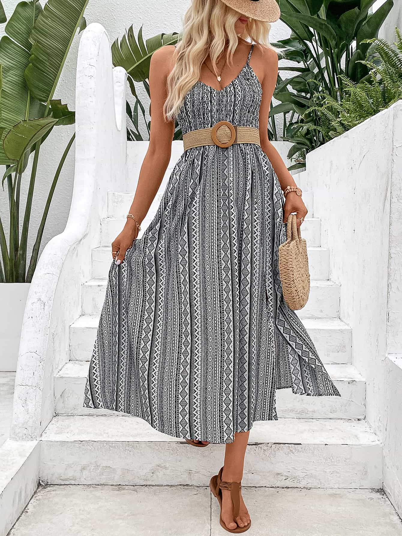 A stylish Printed Spaghetti Strap Slit Dress featuring a vibrant pattern, V-neckline, and a maxi length with a slit hem.