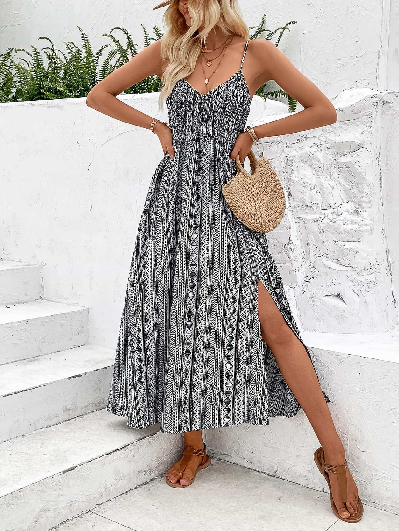 A stylish Printed Spaghetti Strap Slit Dress featuring a vibrant pattern, V-neckline, and a maxi length with a slit hem.