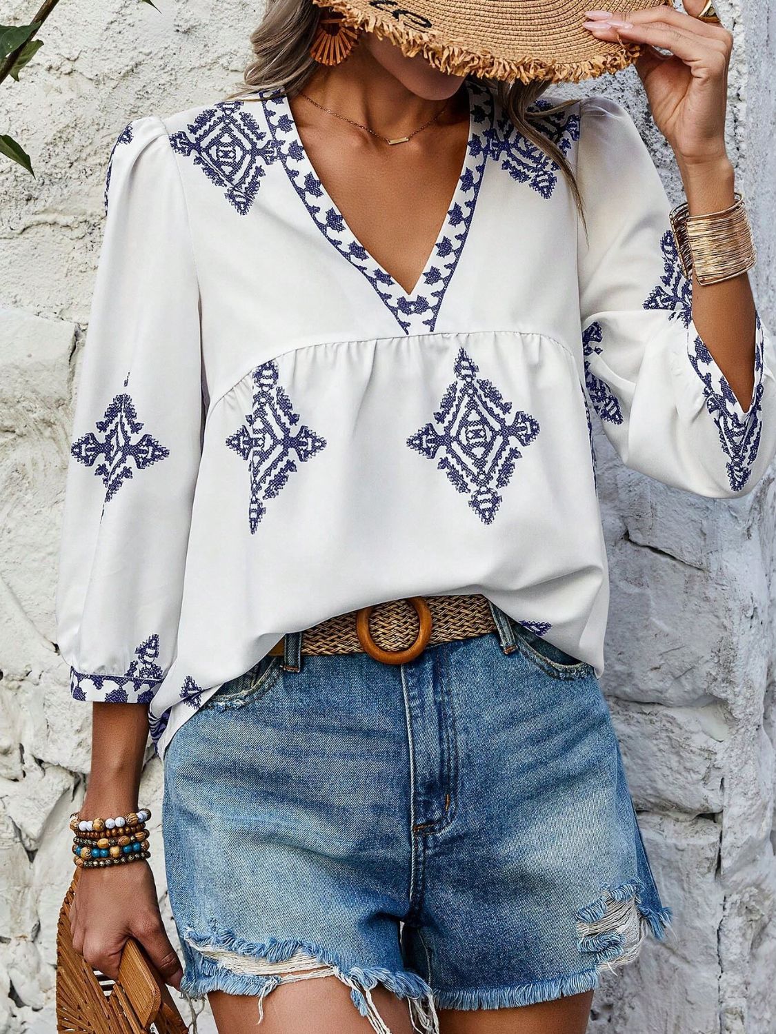 A stylish Printed V-Neck Three-Quarter Sleeve Blouse featuring a vibrant print, designed for comfort and elegance, made from 100% polyester.