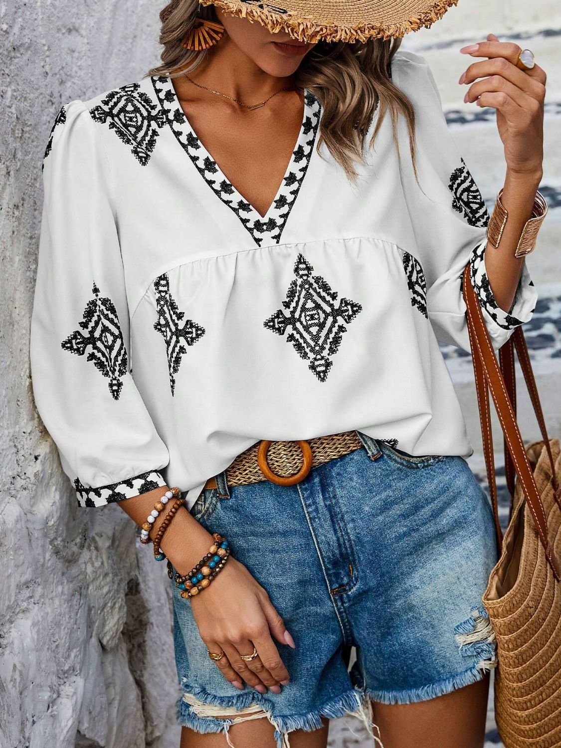 A stylish Printed V-Neck Three-Quarter Sleeve Blouse featuring a vibrant print, designed for comfort and elegance, made from 100% polyester.