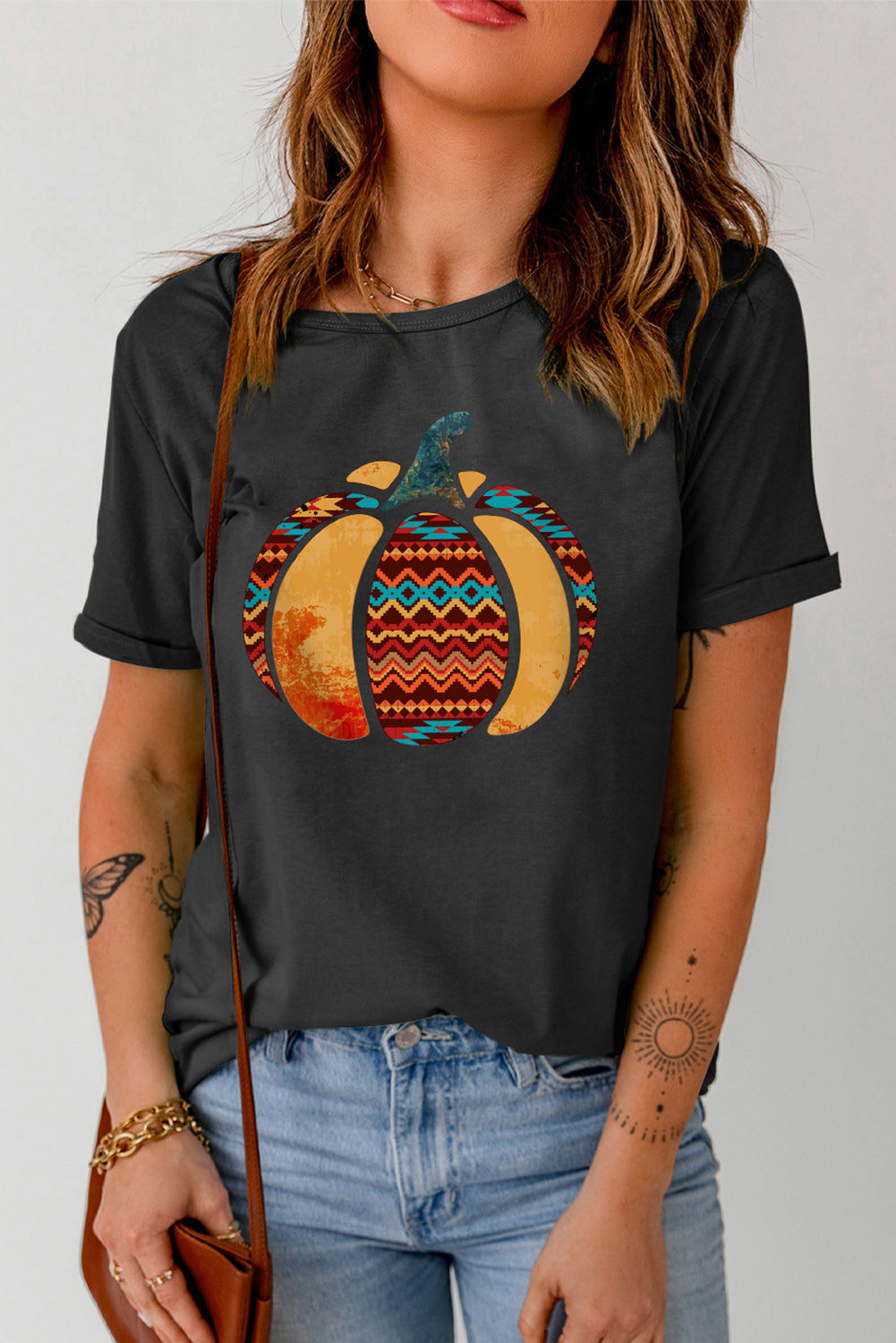 A stylish Pumpkin Graphic Cuffed Tee featuring a chic pumpkin design, round neck, and short sleeves, perfect for casual fall wear.