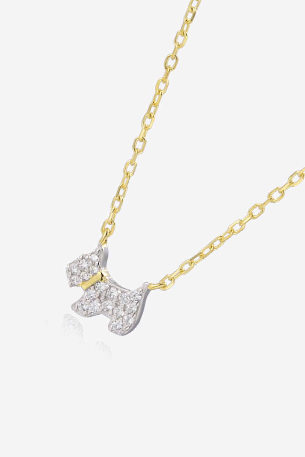 Puppy Zircon 925 Sterling Silver Necklace featuring zircon accents and 18K gold-plated finish, displayed elegantly on a soft background.