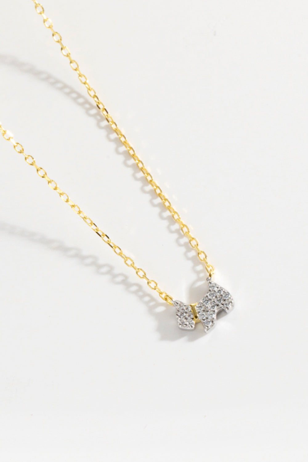 Puppy Zircon 925 Sterling Silver Necklace featuring zircon accents and 18K gold-plated finish, displayed elegantly on a soft background.