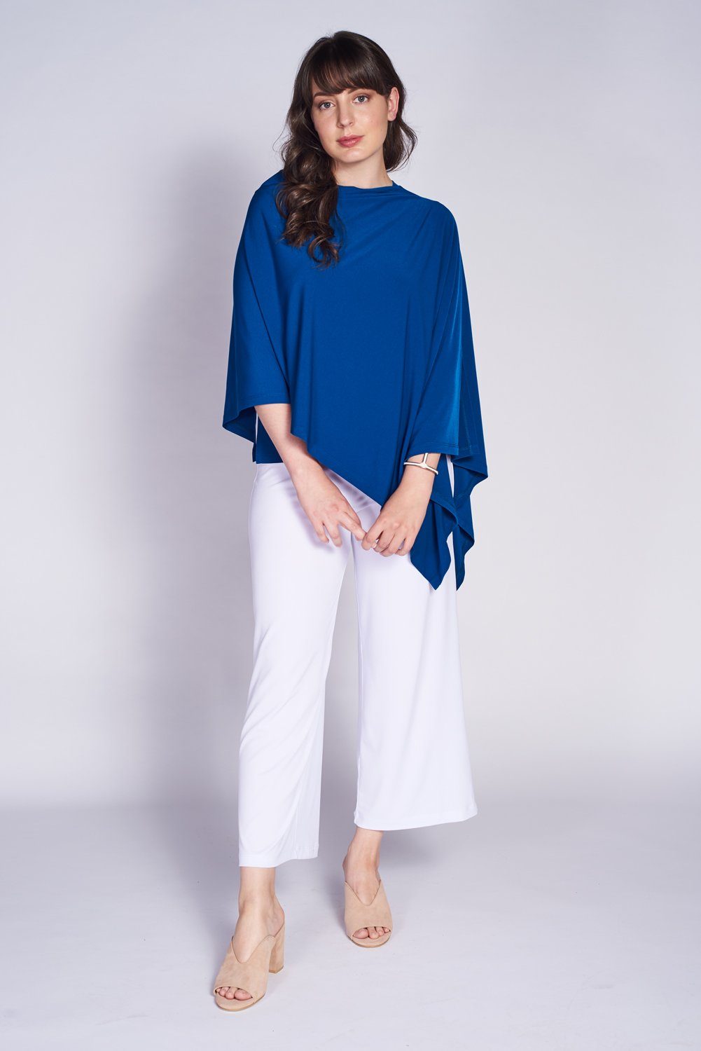 A stylish Pure Poncho in soft stretch knit fabric, showcasing its versatile design and seam detail.