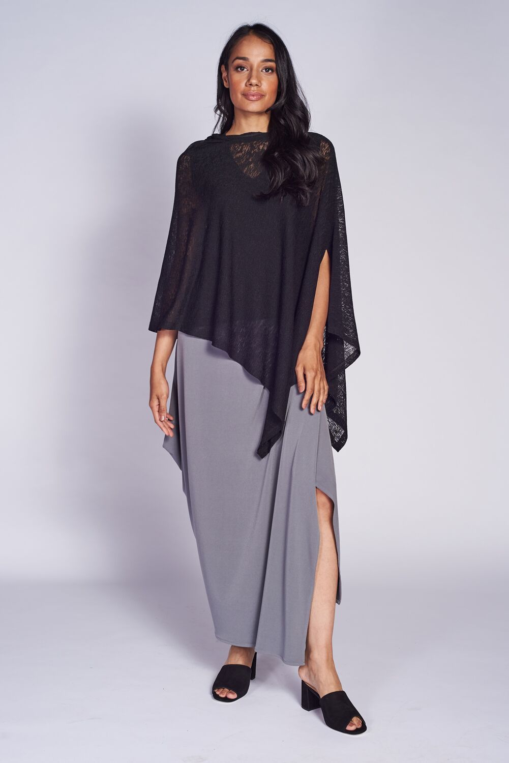 A stylish Pure Poncho in soft stretch knit fabric, showcasing its versatile design and seam detail.