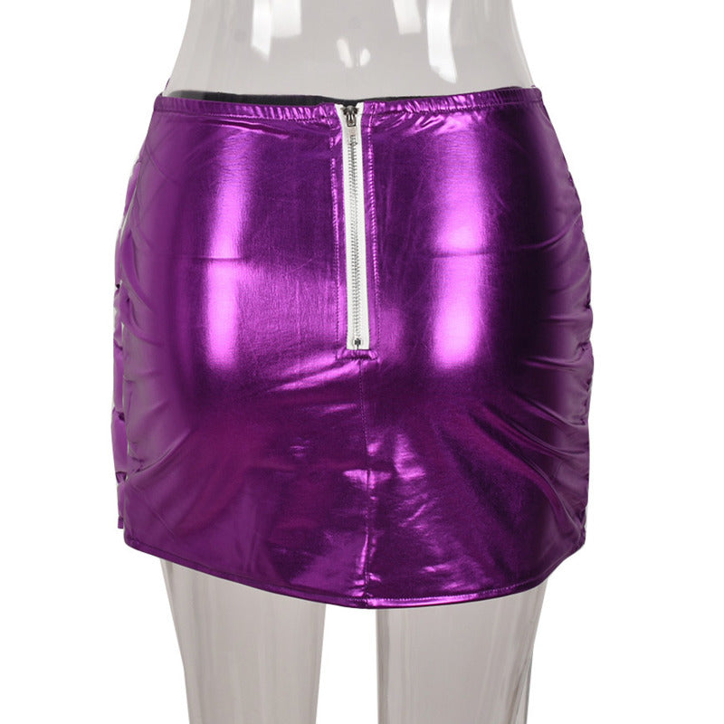 Purple women's puffer skirt with metallic shiny finish, featuring a quilted design and zipper closure, perfect for stylish warmth.