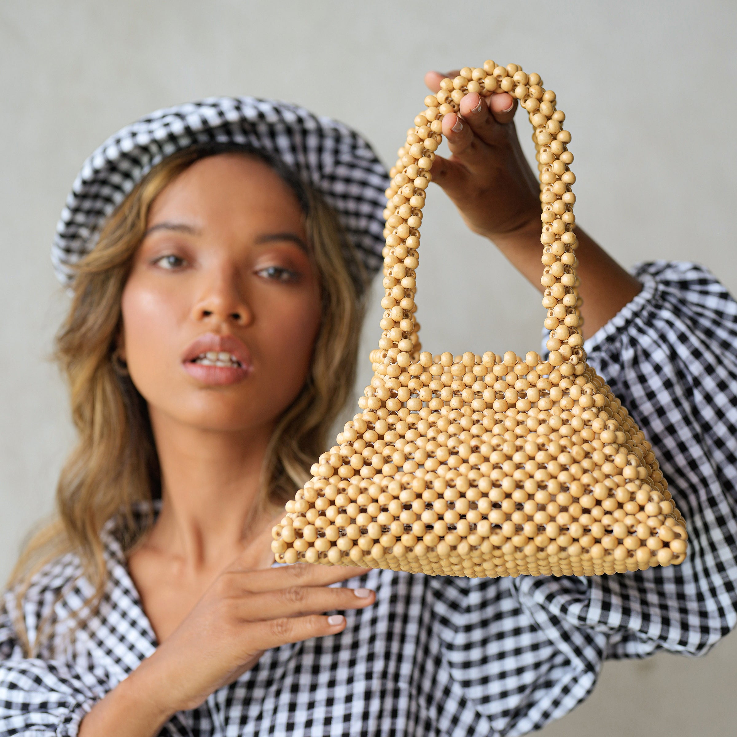 Pyramid Beaded Tote Bag in Toasted Beige featuring natural wooden beads and sturdy handles.