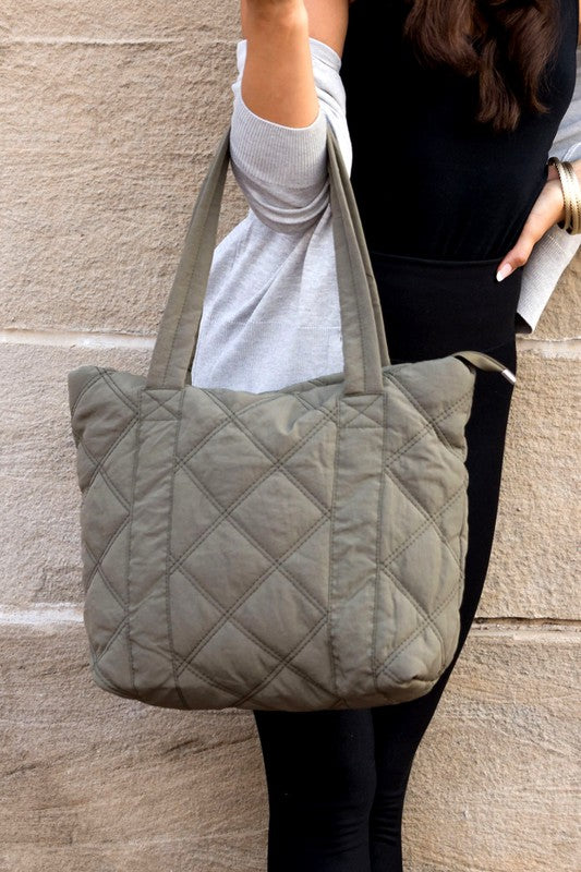 Stylish Quilted Tote with puffed design, top zipper closure, and three interior pockets, perfect for everyday use.