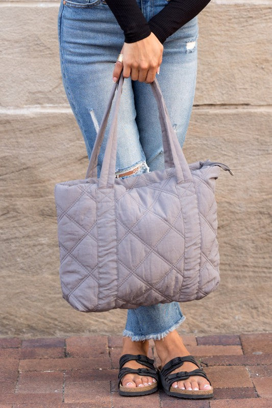 Stylish Quilted Tote with puffed design, top zipper closure, and three interior pockets, perfect for everyday use.