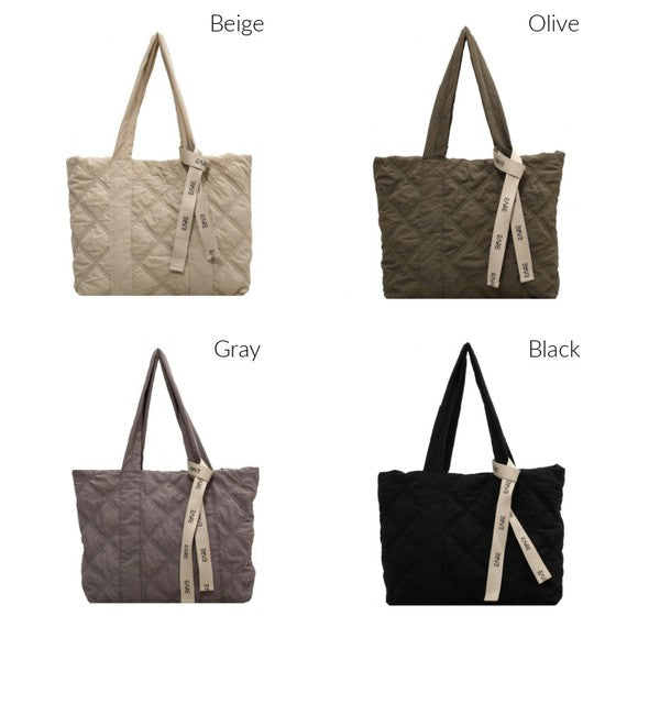 Stylish Quilted Tote with puffed design, top zipper closure, and three interior pockets, perfect for everyday use.