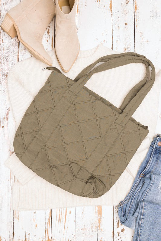 Stylish Quilted Tote with puffed design, top zipper closure, and three interior pockets, perfect for everyday use.