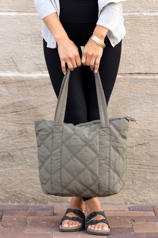 Stylish Quilted Tote with puffed design, top zipper closure, and three interior pockets, perfect for everyday use.