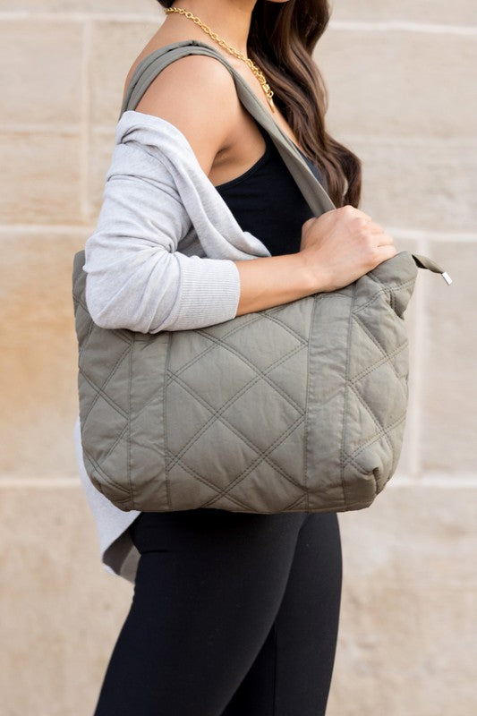 Stylish Quilted Tote with puffed design, top zipper closure, and three interior pockets, perfect for everyday use.