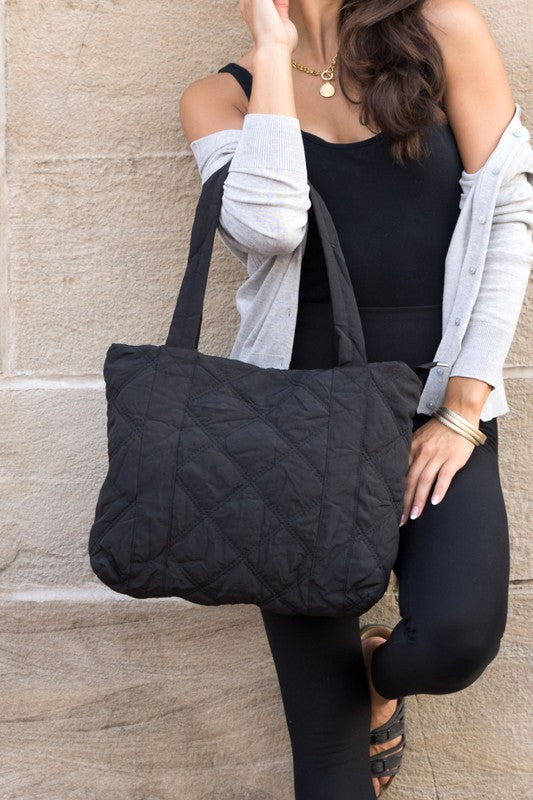 Stylish Quilted Tote with puffed design, top zipper closure, and three interior pockets, perfect for everyday use.