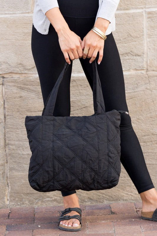 Stylish Quilted Tote with puffed design, top zipper closure, and three interior pockets, perfect for everyday use.