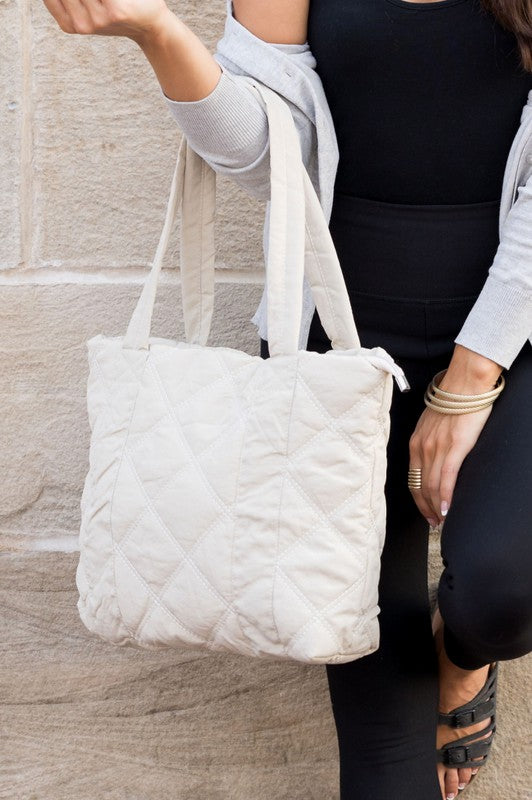 Stylish Quilted Tote with puffed design, top zipper closure, and three interior pockets, perfect for everyday use.