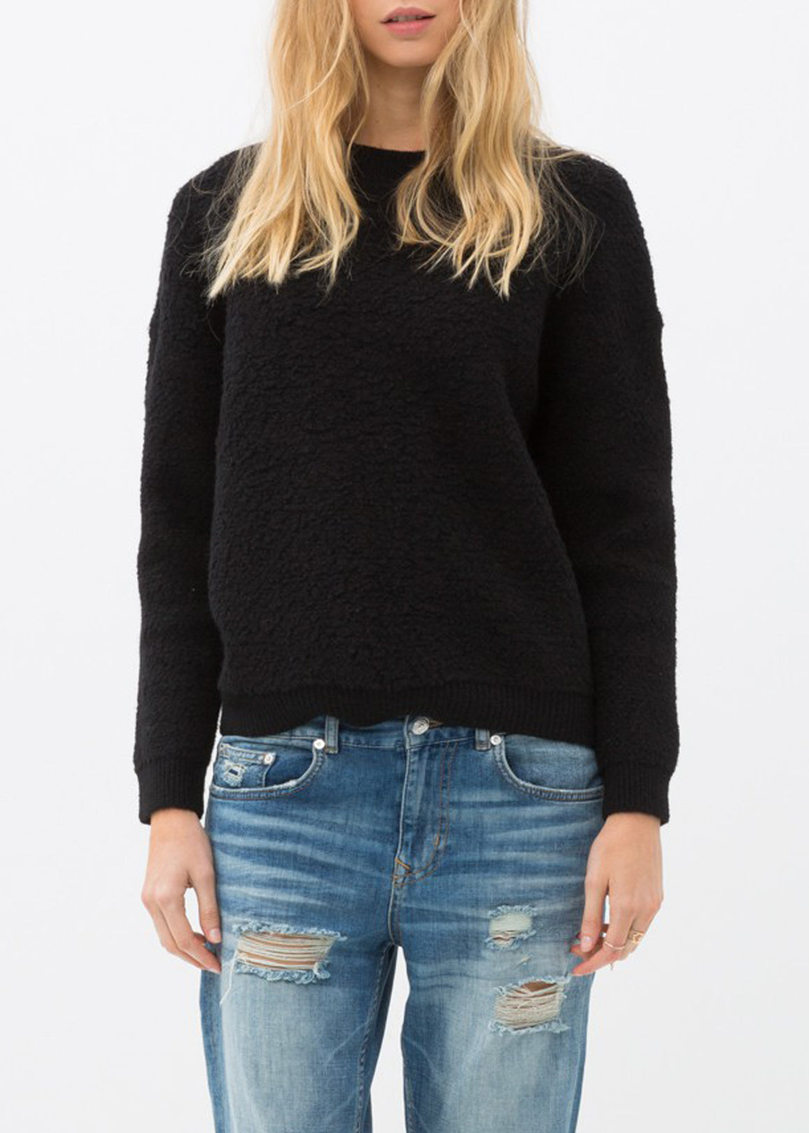 A cozy women's rag wool knit crew neck sweater in a classic design, showcasing its soft texture and warm fabric, perfect for winter wear.