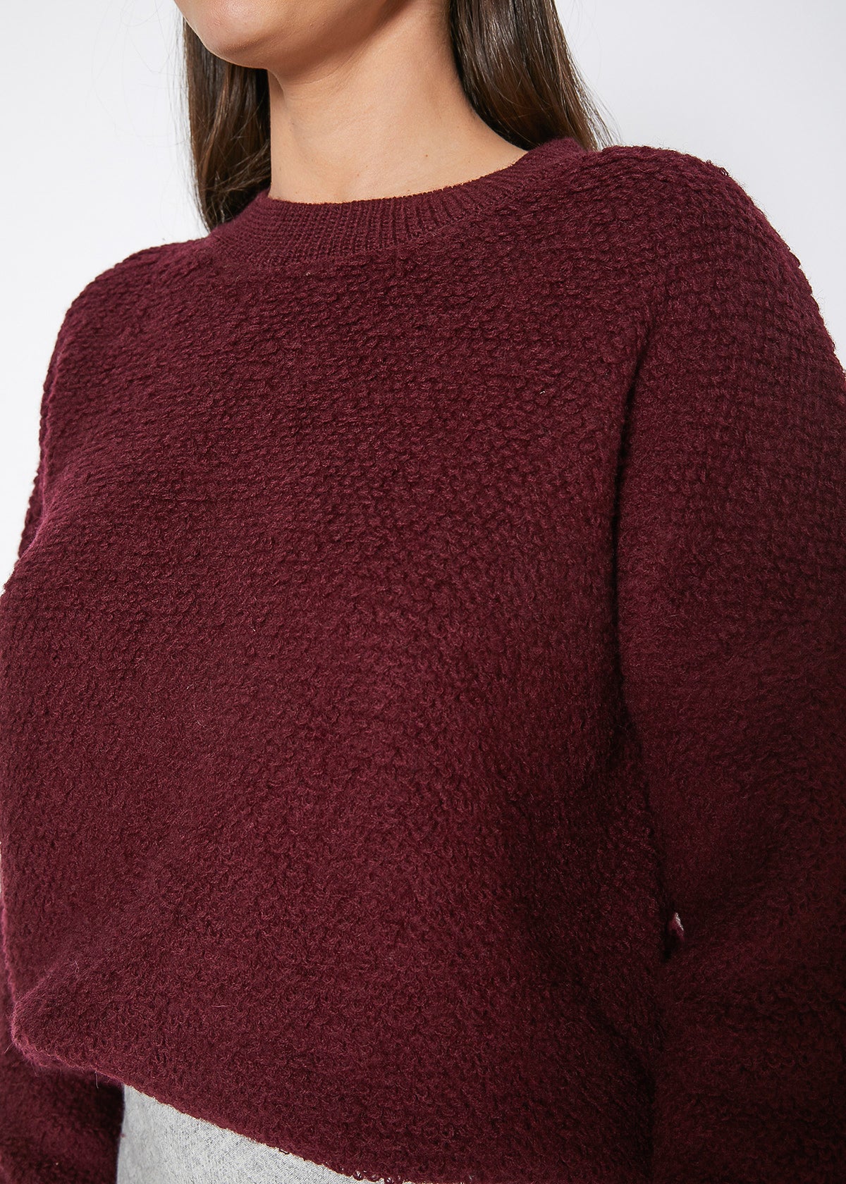 A cozy women's rag wool knit crew neck sweater in a classic design, showcasing its soft texture and warm fabric, perfect for winter wear.