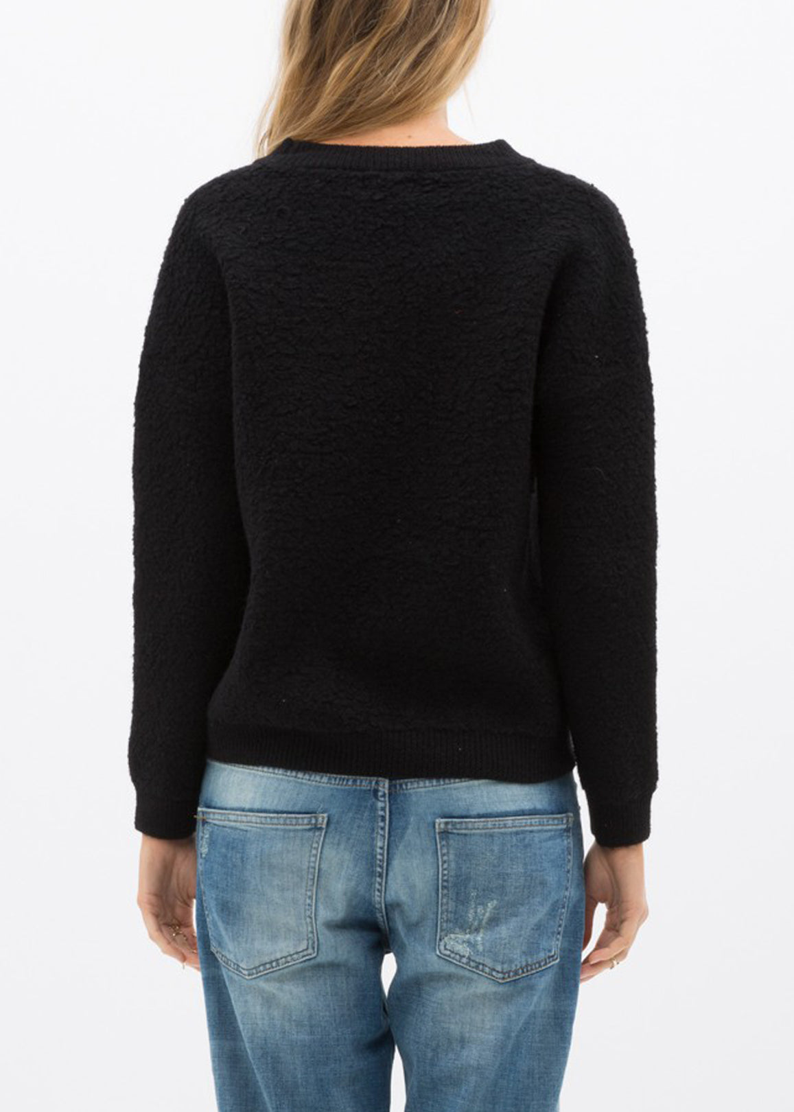 A cozy women's rag wool knit crew neck sweater in a classic design, showcasing its soft texture and warm fabric, perfect for winter wear.