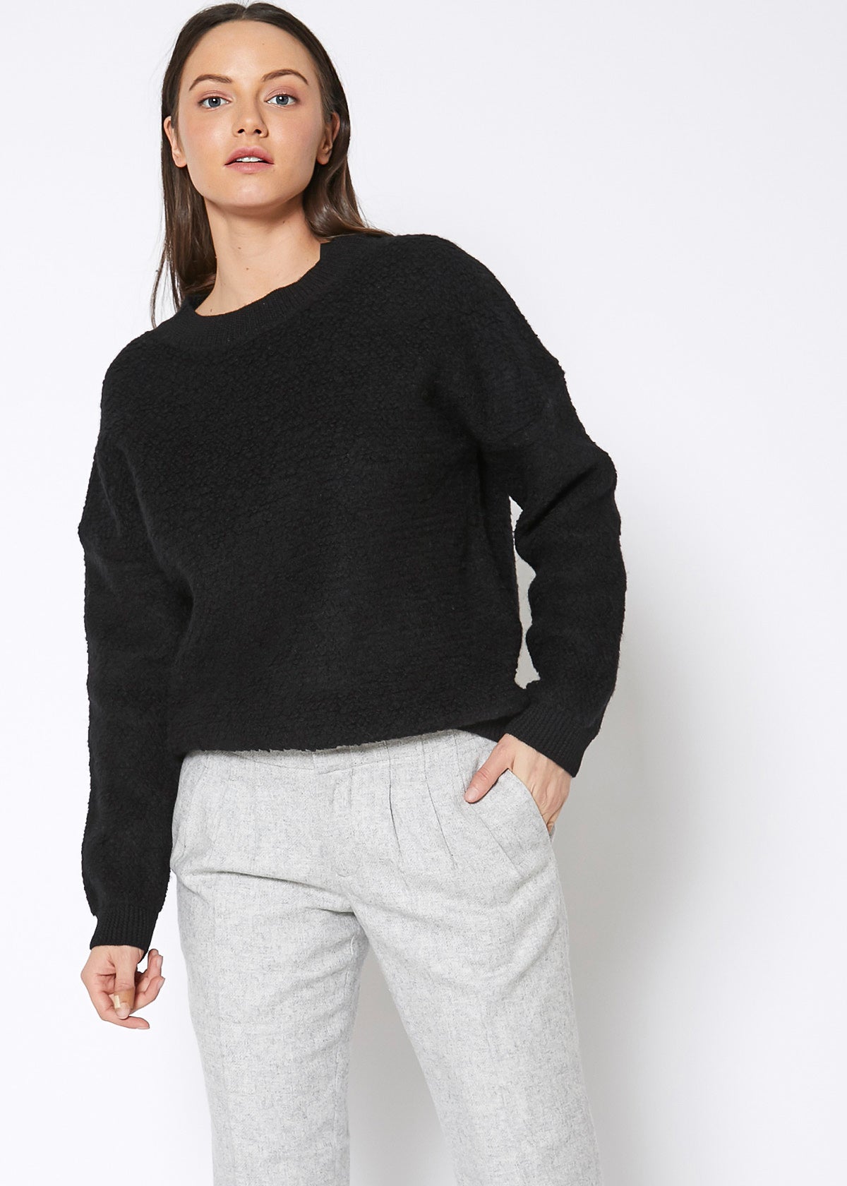 A cozy women's rag wool knit crew neck sweater in a classic design, showcasing its soft texture and warm fabric, perfect for winter wear.