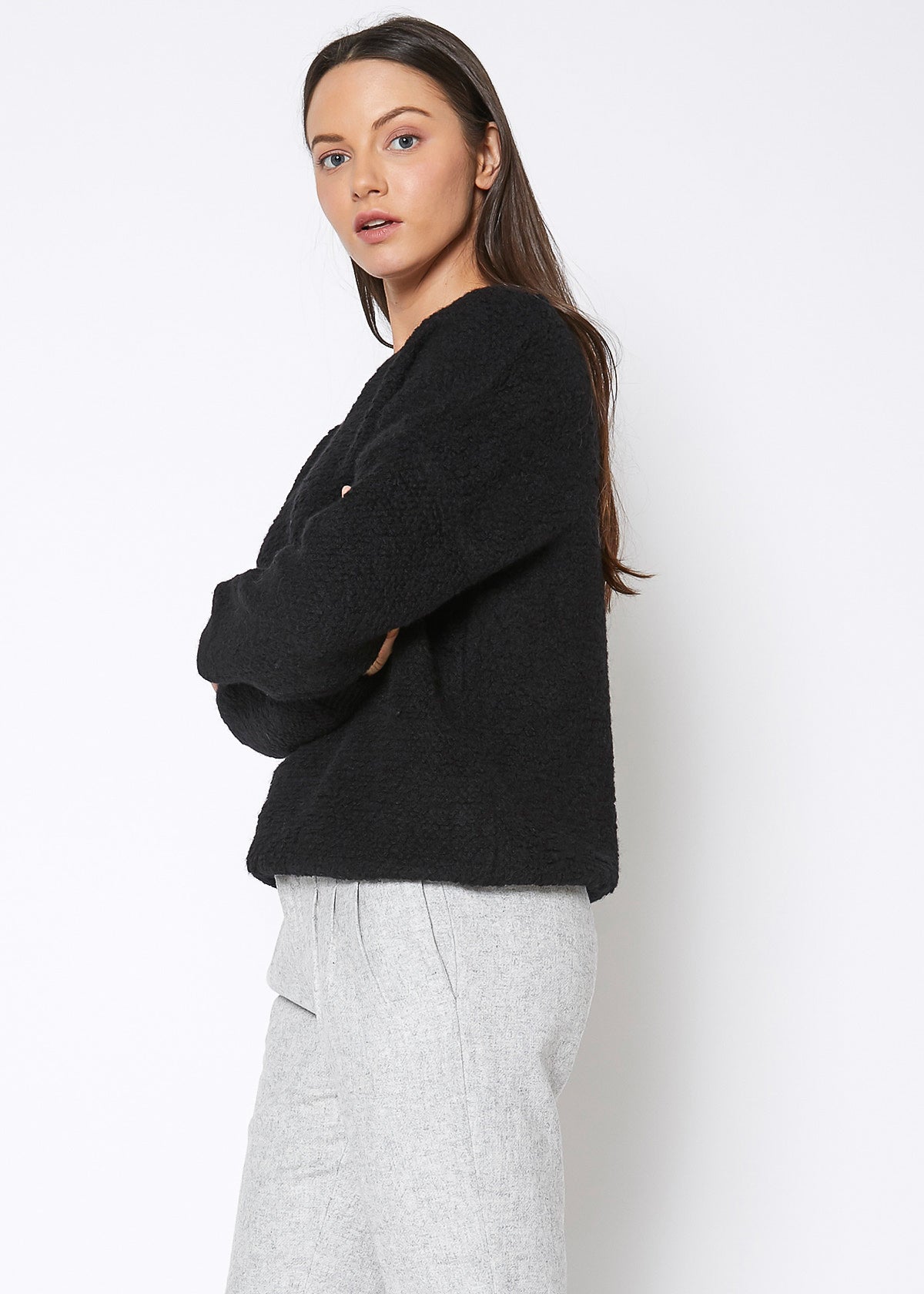 A cozy women's rag wool knit crew neck sweater in a classic design, showcasing its soft texture and warm fabric, perfect for winter wear.