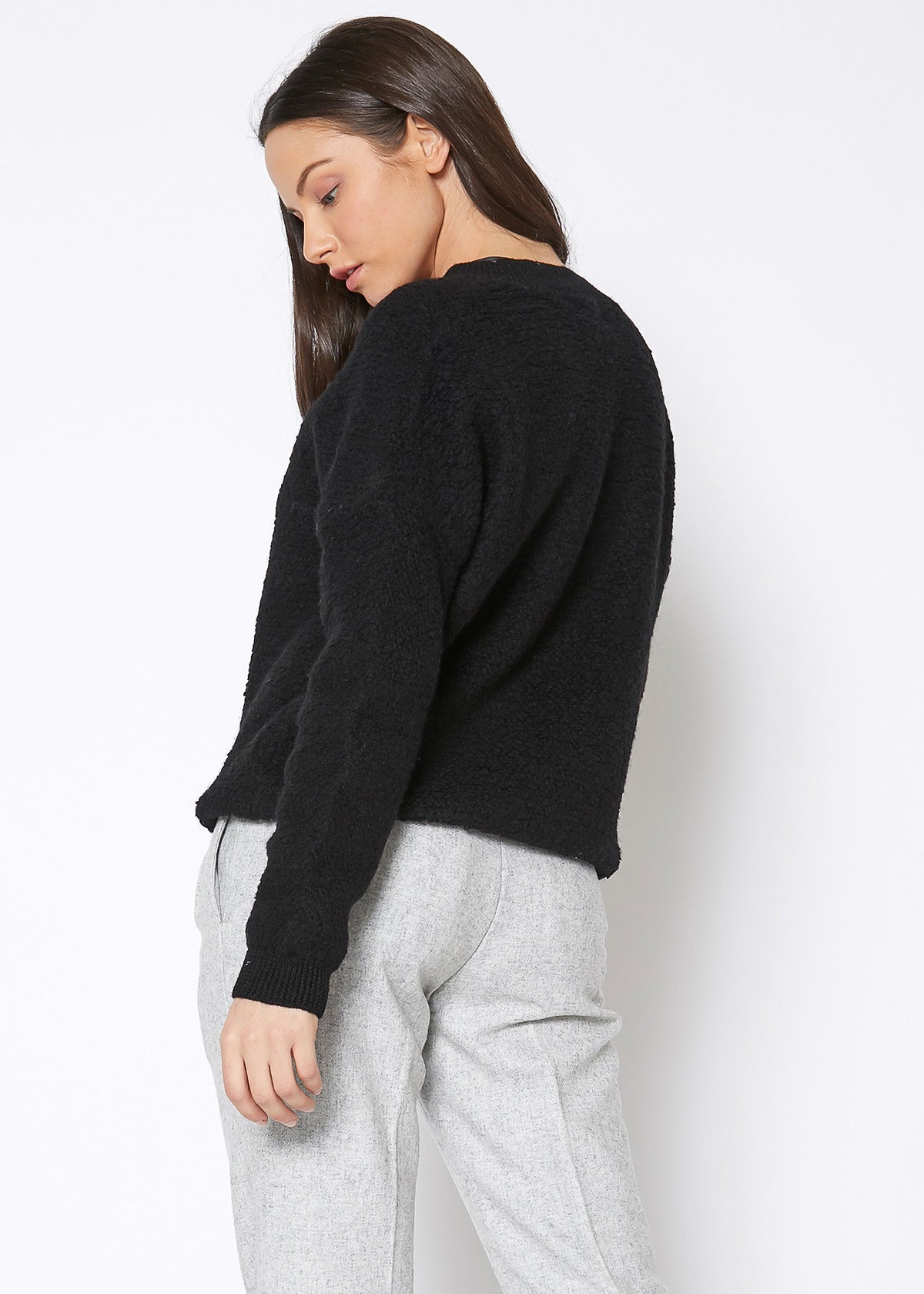 A cozy women's rag wool knit crew neck sweater in a classic design, showcasing its soft texture and warm fabric, perfect for winter wear.