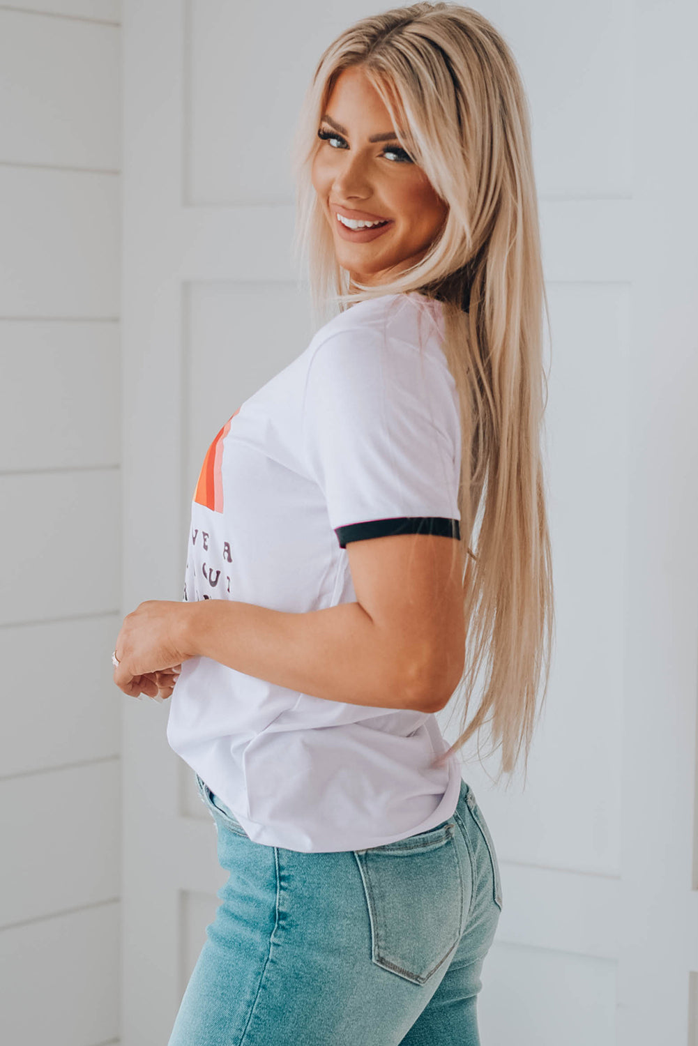 A colorful rainbow graphic short sleeve tee displayed on a mannequin, showcasing its casual style and round neckline.