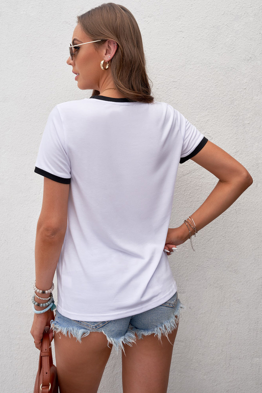 A colorful rainbow graphic short sleeve tee displayed on a mannequin, showcasing its casual style and round neckline.