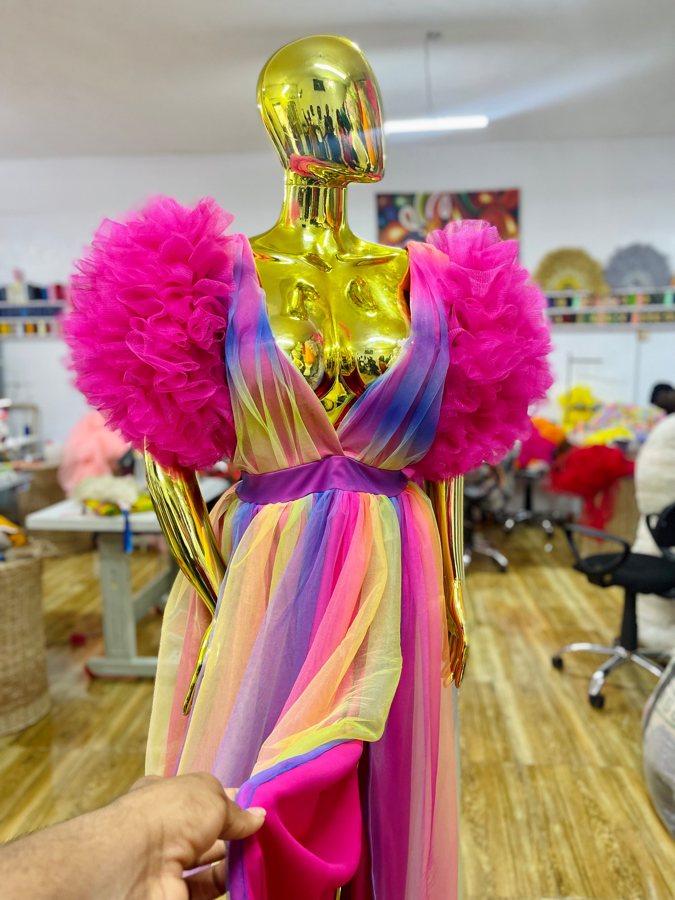 A vibrant Rainbow Ixora Dress featuring puffy ruffle sleeves and a stylish slit, perfect for all occasions.