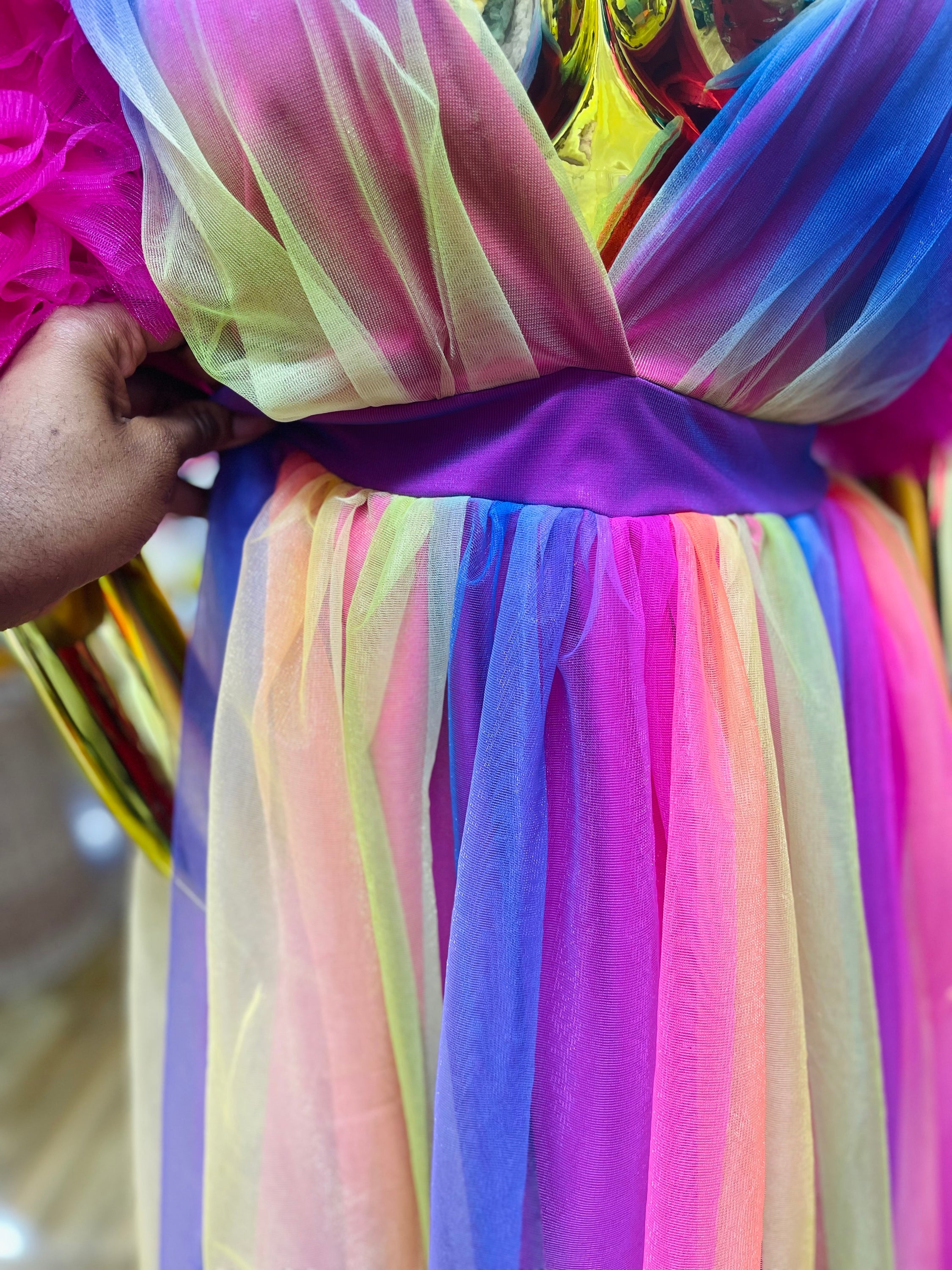 A vibrant Rainbow Ixora Dress featuring puffy ruffle sleeves and a stylish slit, perfect for all occasions.