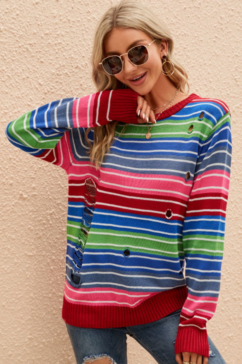 A vibrant Rainbow Stripe Distressed Round Neck Sweater featuring a colorful striped pattern, round neckline, and long sleeves, perfect for casual wear.