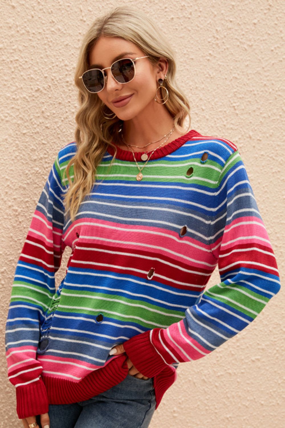 A vibrant Rainbow Stripe Distressed Round Neck Sweater featuring a colorful striped pattern, round neckline, and long sleeves, perfect for casual wear.