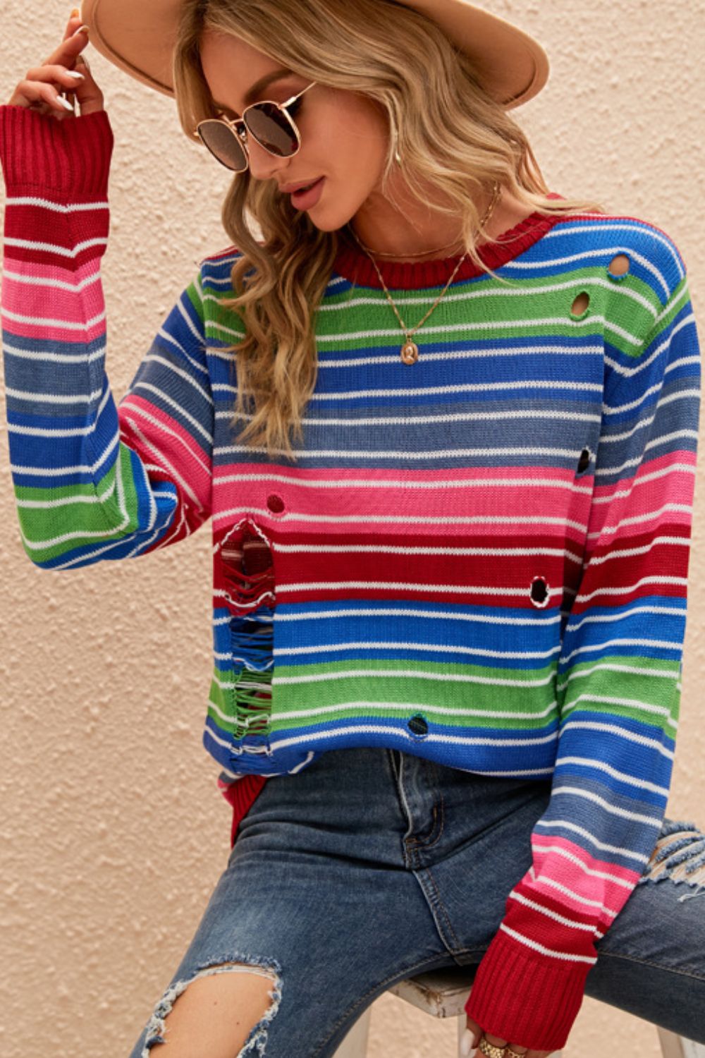 A vibrant Rainbow Stripe Distressed Round Neck Sweater featuring a colorful striped pattern, round neckline, and long sleeves, perfect for casual wear.