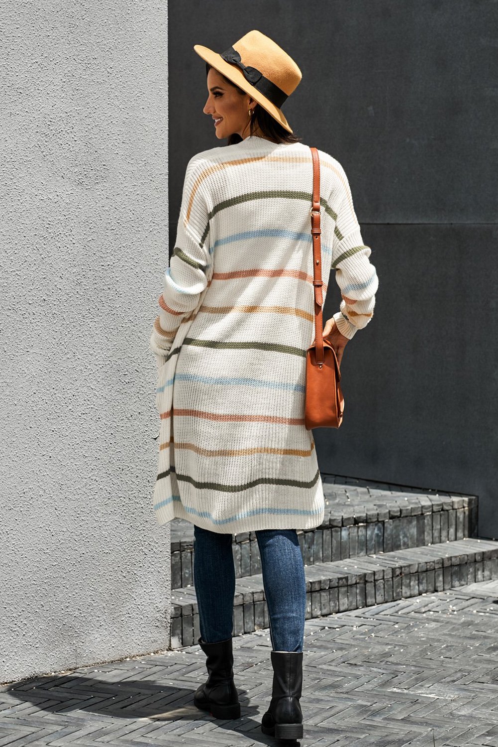 A cozy Rainbow Striped Cardigan featuring vibrant colors and a soft knitted texture, perfect for layering in any season.