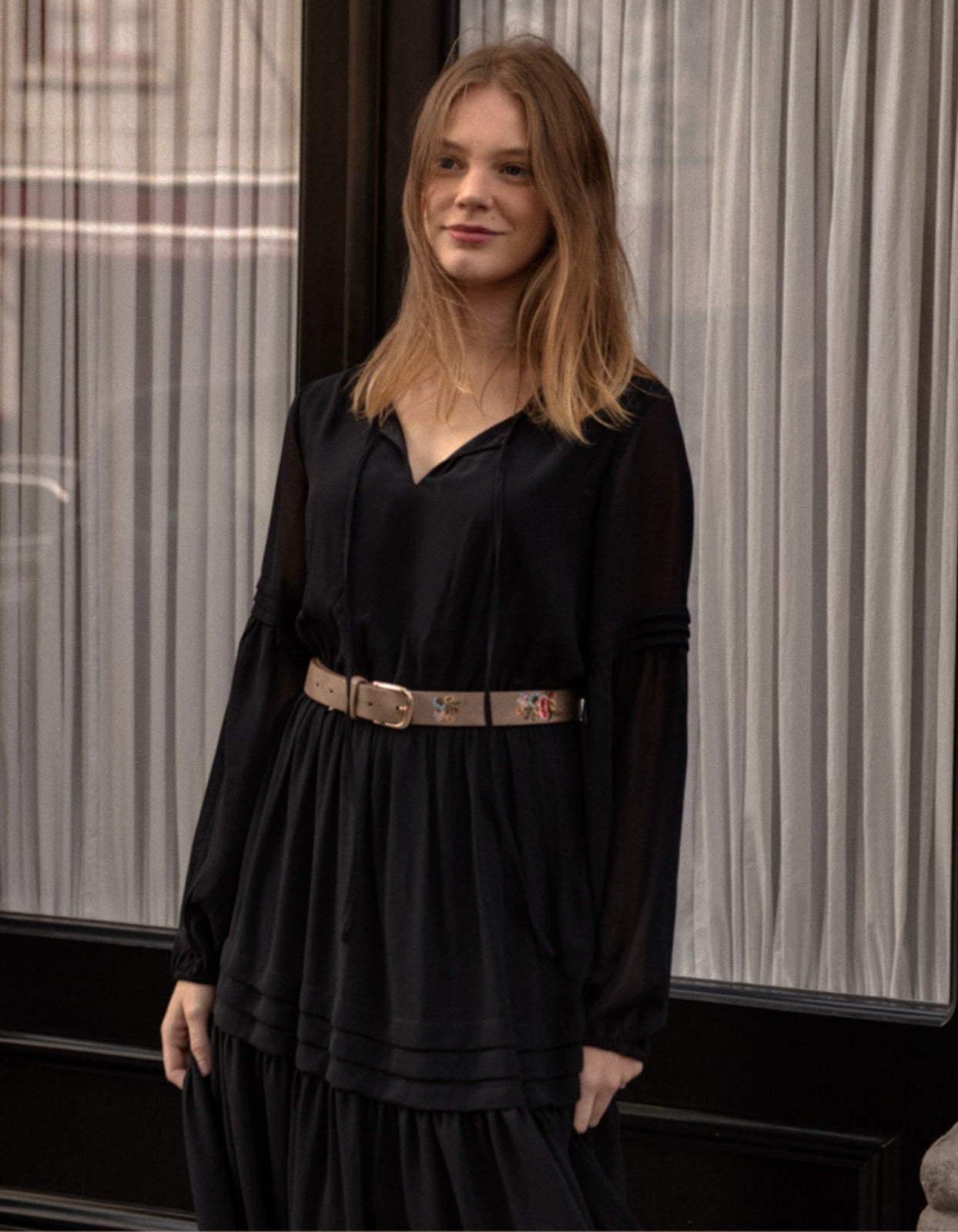 Raissa Midi Dress in solid black featuring a tiered skirt, semi-sheer sleeves, and a keyhole neckline detail.