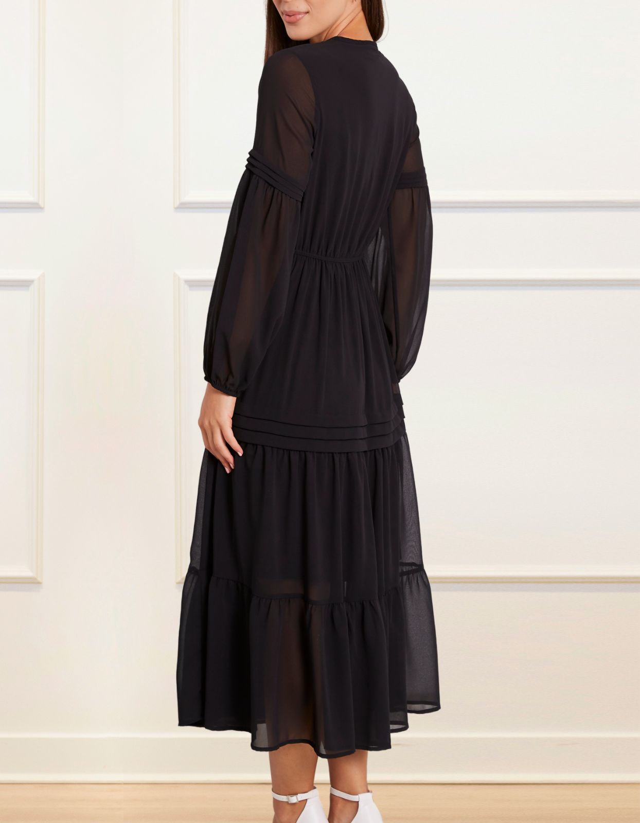 Raissa Midi Dress in solid black featuring a tiered skirt, semi-sheer sleeves, and a keyhole neckline detail.