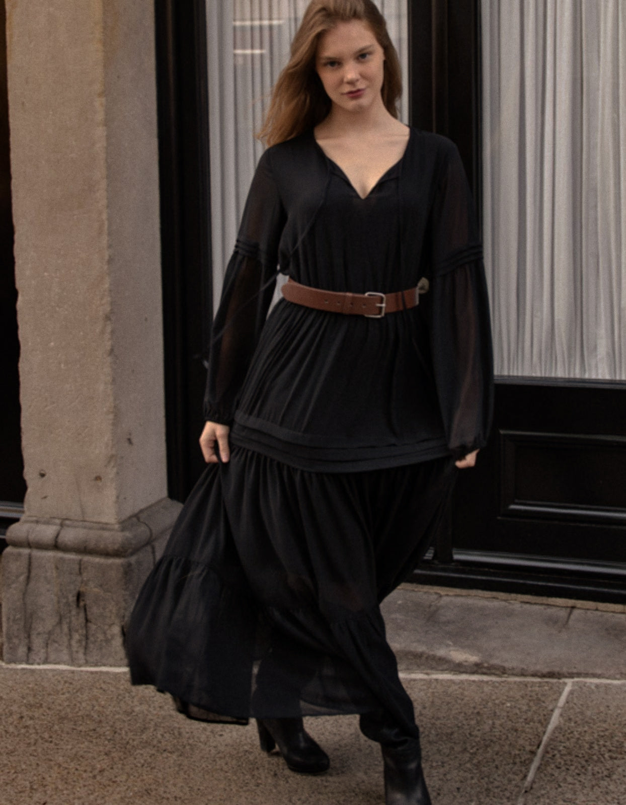 Raissa Midi Dress in solid black featuring a tiered skirt, semi-sheer sleeves, and a keyhole neckline detail.