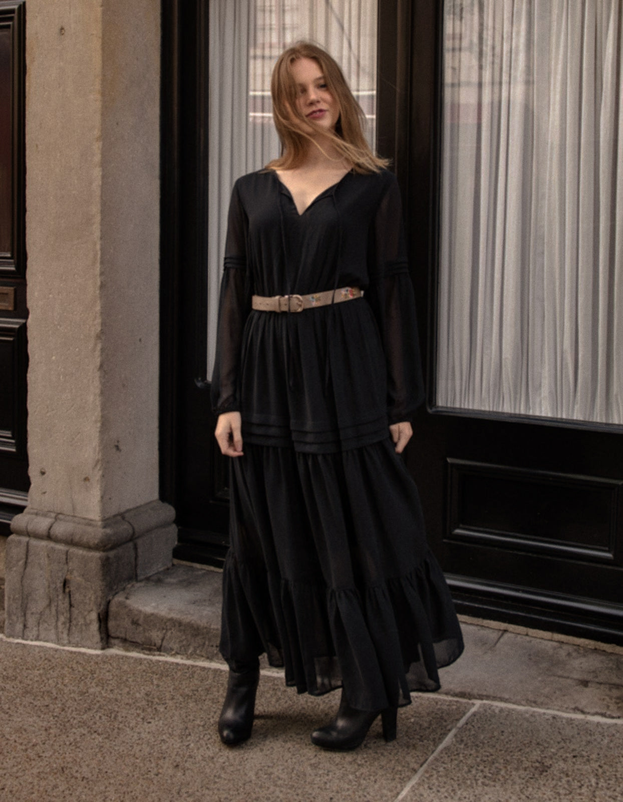 Raissa Midi Dress in solid black featuring a tiered skirt, semi-sheer sleeves, and a keyhole neckline detail.