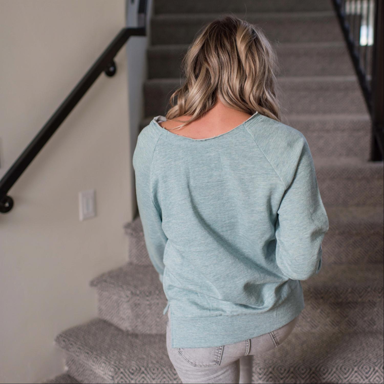 A stylish oversized Raw Neck Top in elegant pastel colors, featuring a slouchy raw-hem neckline and voluminous sleeves.