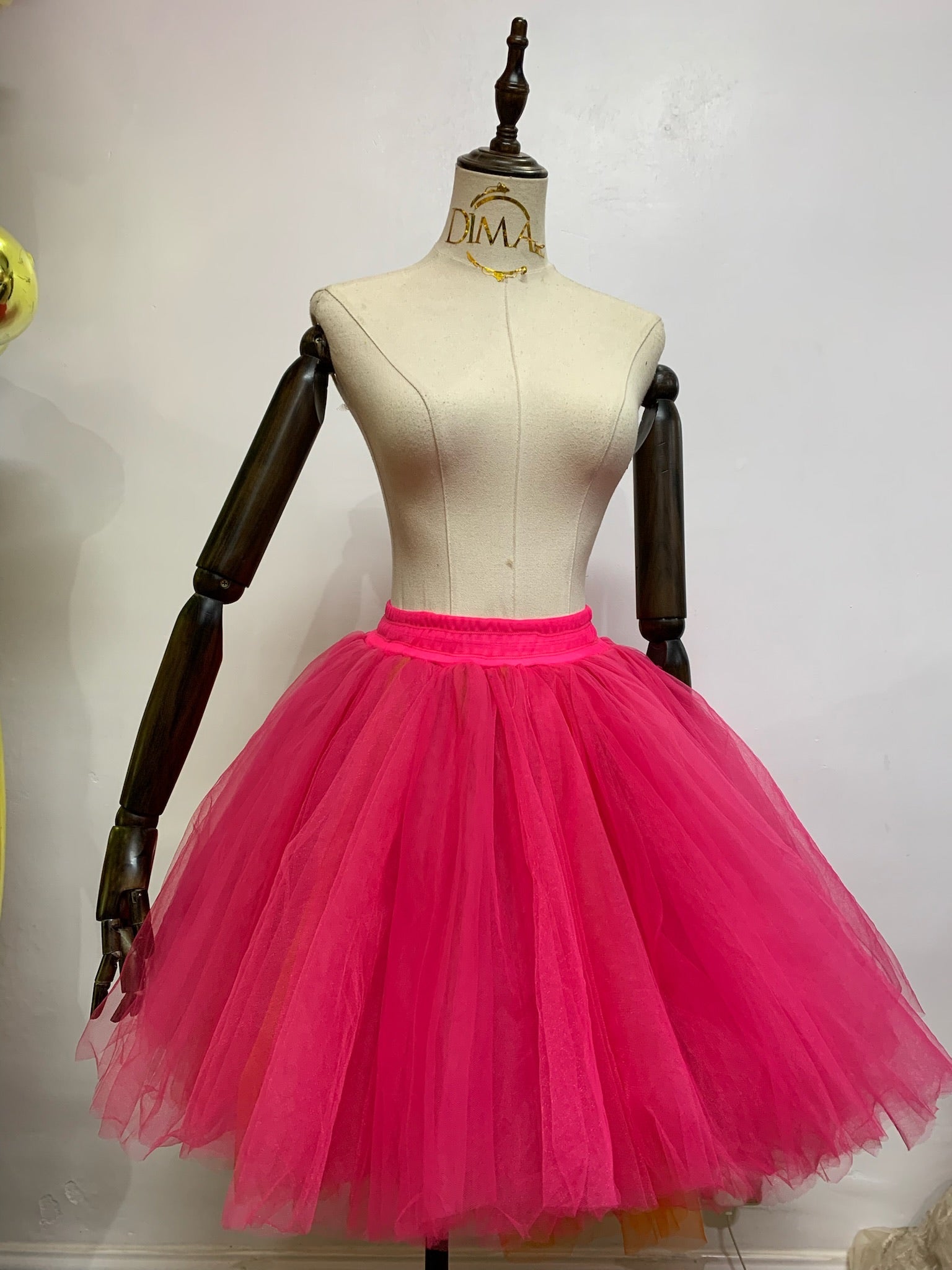 A fluffy tulle skirt in a soft pastel color, showcasing layers of delicate fabric for a whimsical and elegant look.